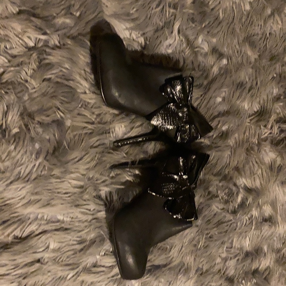 Black booties with faux snake skin bows